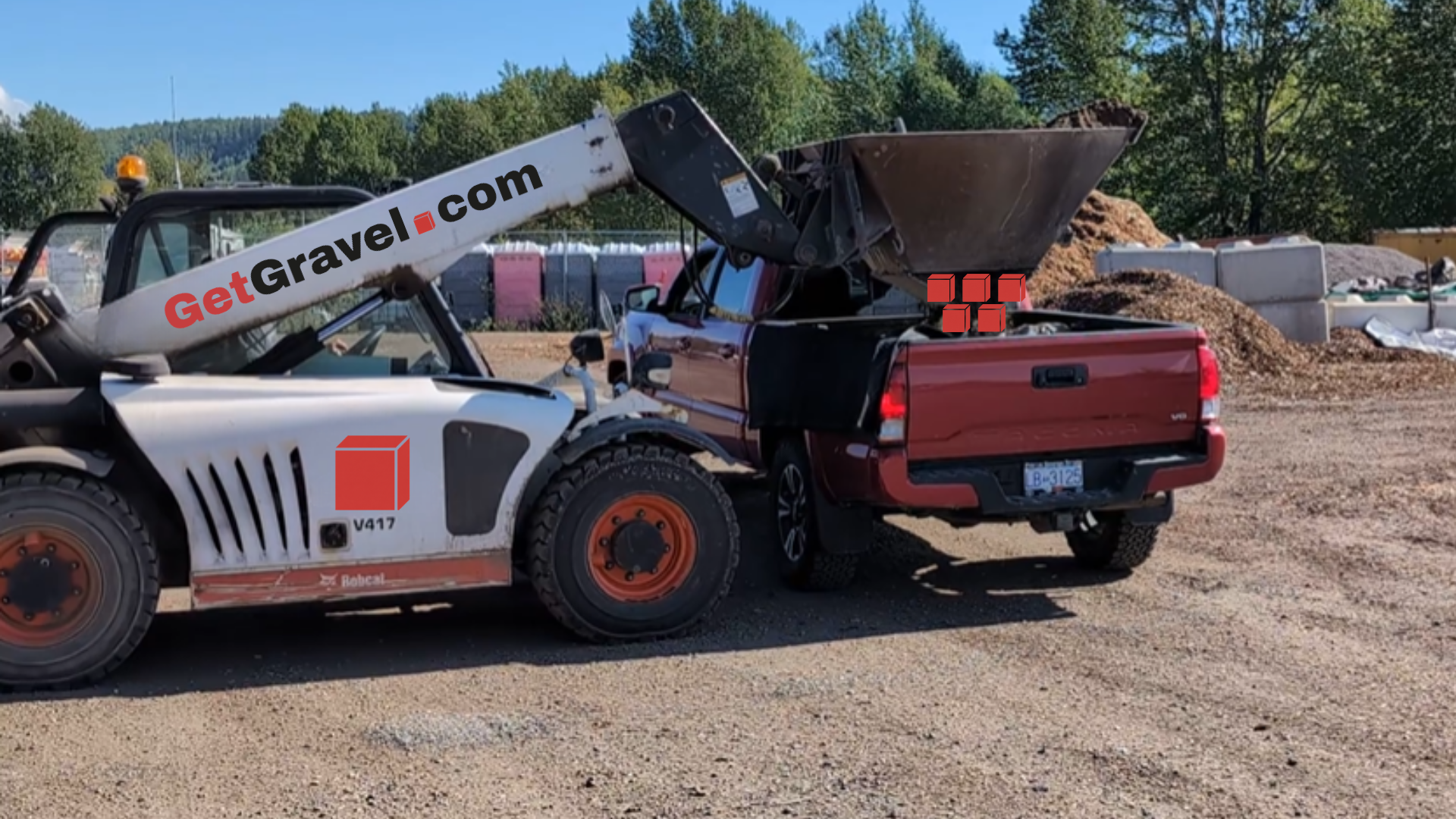 The bottom-opening bucket loading a pickup or trailer.
